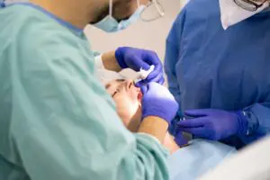 Oral surgeon performing a surgery