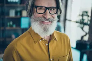 Man with confident restored smile implant dentistry concept