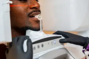 Dentist performing a dental x ray scan on a patient inside a modern dental clinic, ensuring accurate diagnosis and optimal oral health