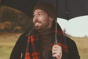 https://pixabay.com/photos/man-umbrella-outdoor-happy-german-4821291/ Man smiling holding an umbrella