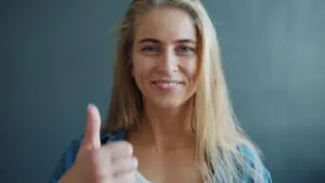 https://www.pexels.com/photo/smiling-woman-showing-thumbs-up-in-studio-36763587/ Woman smiling giving thumbs up