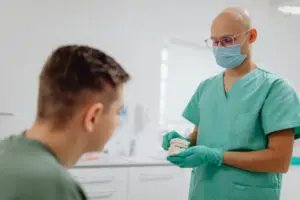 https://www.pexels.com/photo/dentist-having-a-discussion-with-a-patient-6627325/ Dentist explaining procedure to patient