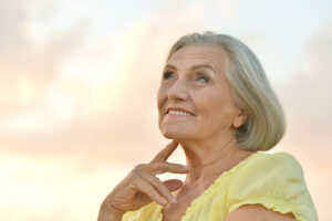 happy senior woman all-on-4 implant concept