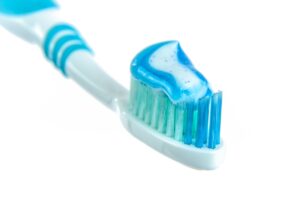 Photo by AS Photography: https://www.pexels.com/photo/blue-and-white-toothpaste-on-toothbrush-216729/ - toothbrush with toothpaste to support oral health